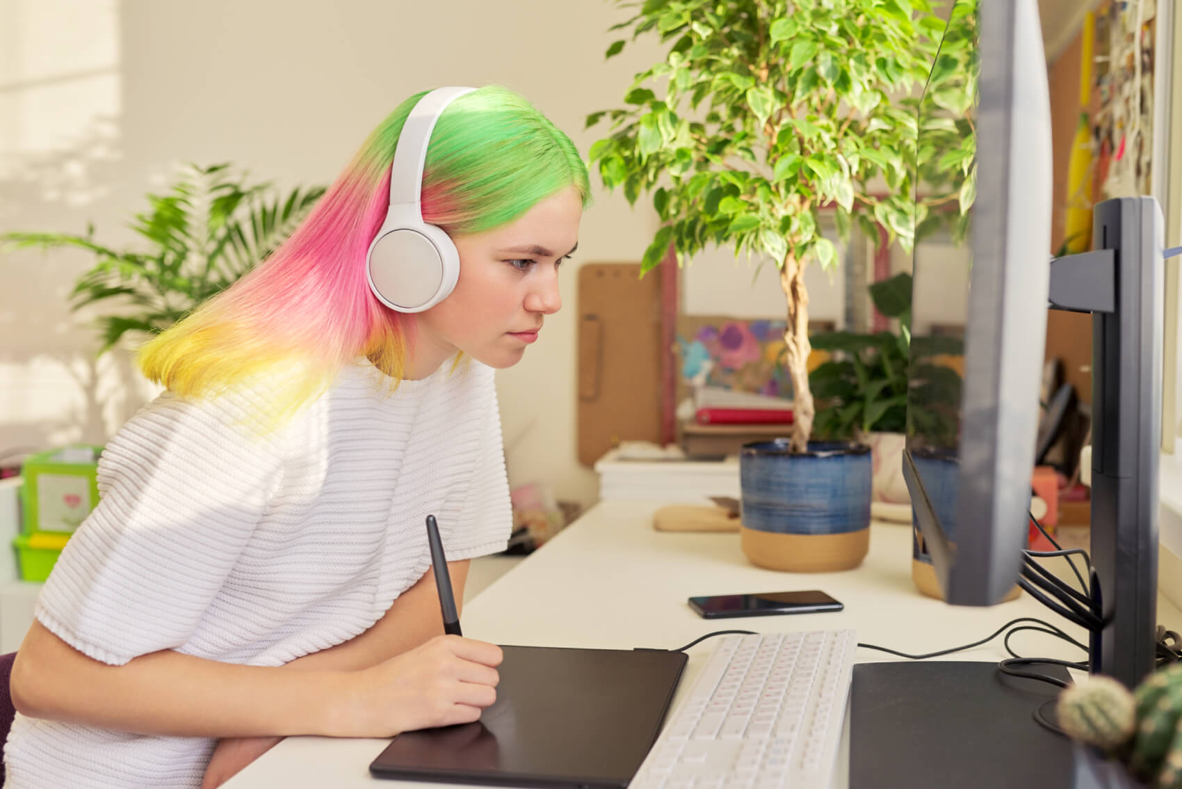 a person wearing headphones and sitting at a desk