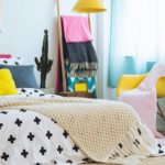 a bed with a white sheet and a white and black pillow