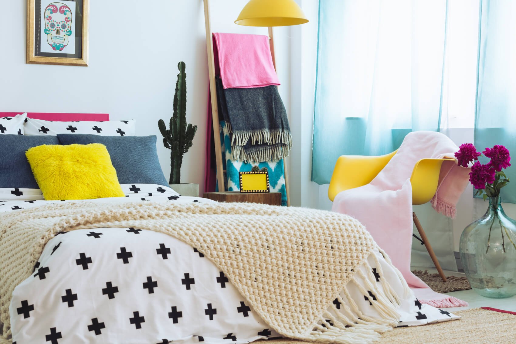 a bed with a white sheet and a white and black pillow