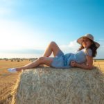 a person lying on a bale of hay