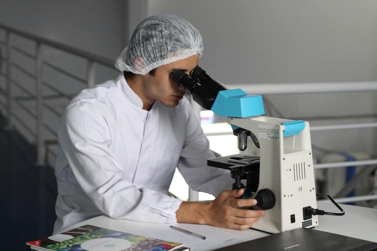 a man wearing a white lab coat