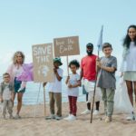 a group of people holding signs on a beach