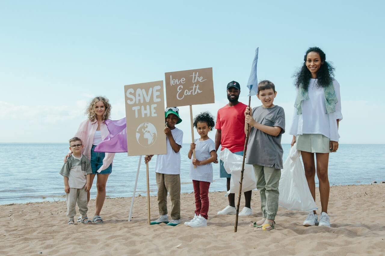 a group of people holding signs on a beach