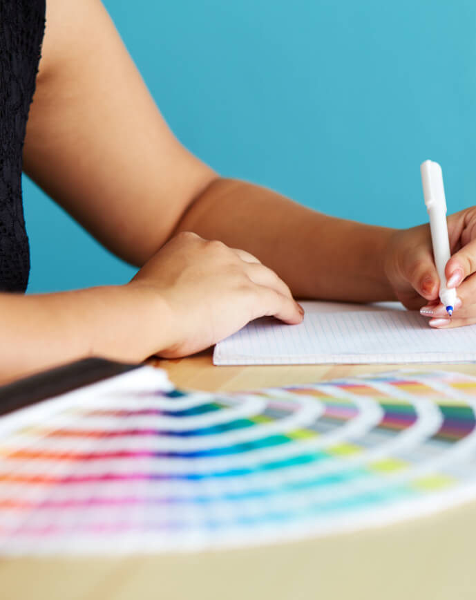 a close-up of a person writing on a piece of paper